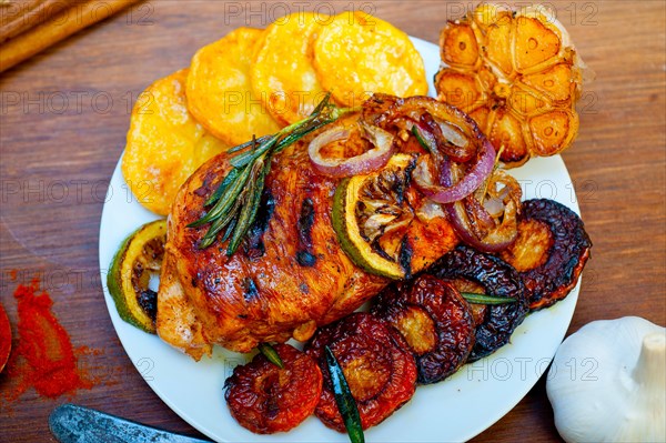Roasted grilled BBQ chicken breast with herbs and spices rustic style