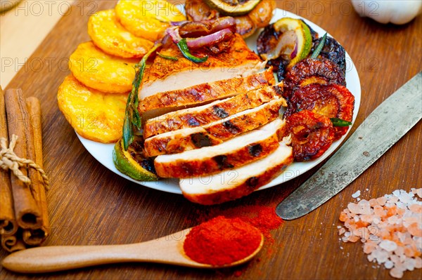 Roasted grilled BBQ chicken breast with herbs and spices rustic style