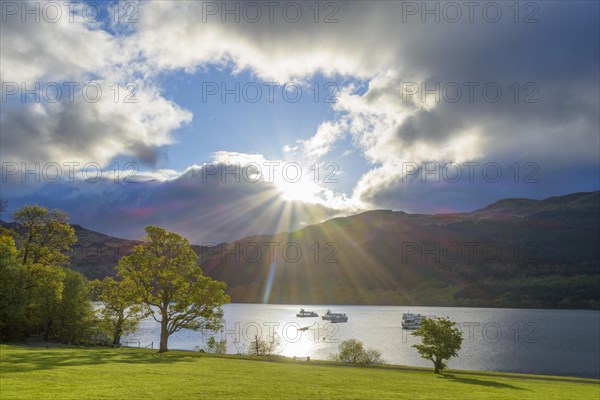 Lake with dramatic clouds and sun in spring