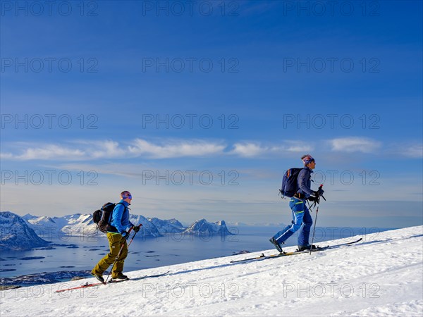 Mountain guide with his guest ascending onto the Bergsfjord with skis