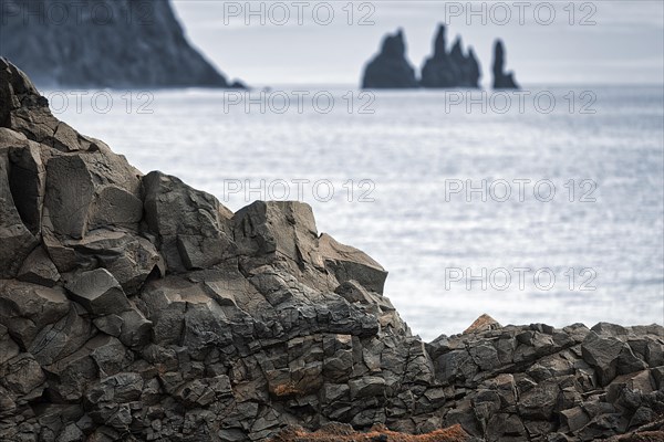 Basalt rocks with a view of the sea and the rock needles Reynisdrangar