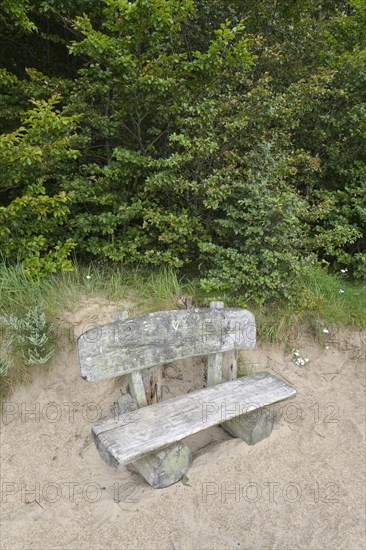 Bench on steep coast at sunrise