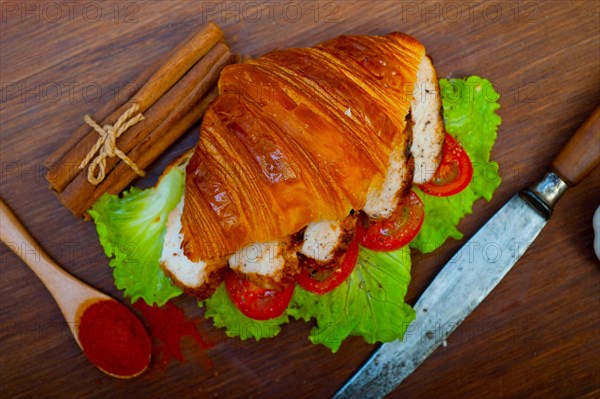 Savory croissant brioche bread with chicken breast and vegetable rustic style