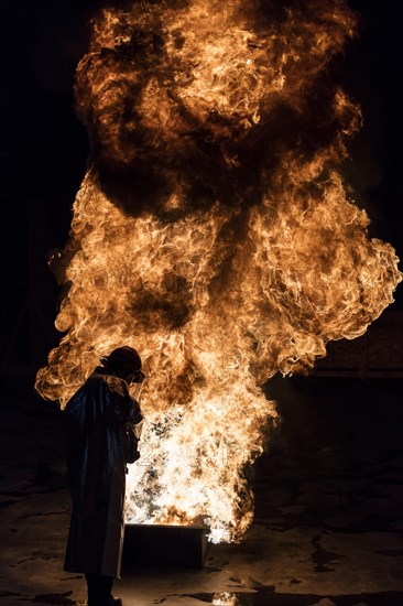 Firefighter extinguishes a heptane 2B-Pan fire with a 2-BTP extinguisher