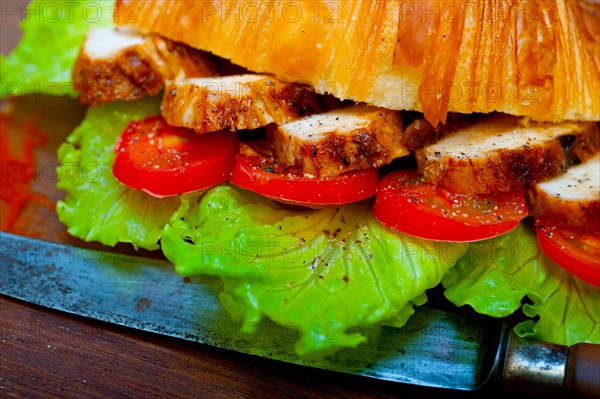 Savory croissant brioche bread with chicken breast and vegetable rustic style