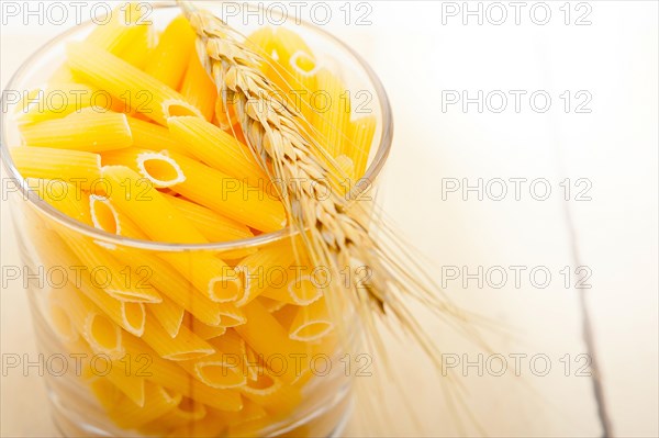 Short Italian pasta penne with durum wheat grains