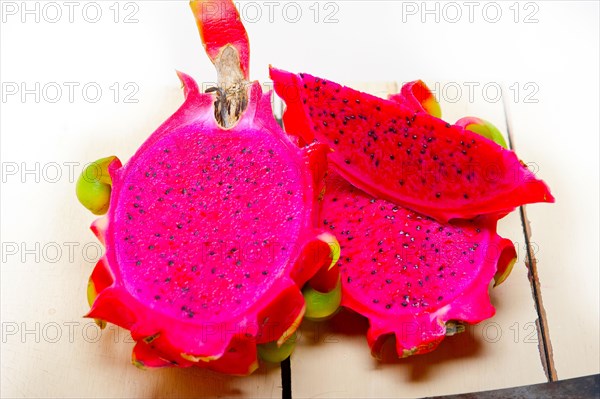 Fresh thai purple dragon fruit over white rustic table