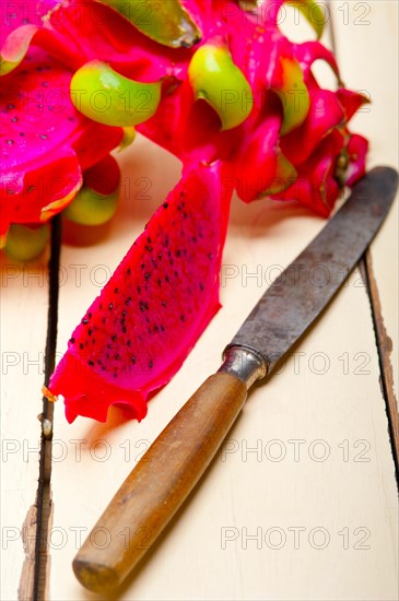 Fresh thai purple dragon fruit over white rustic table