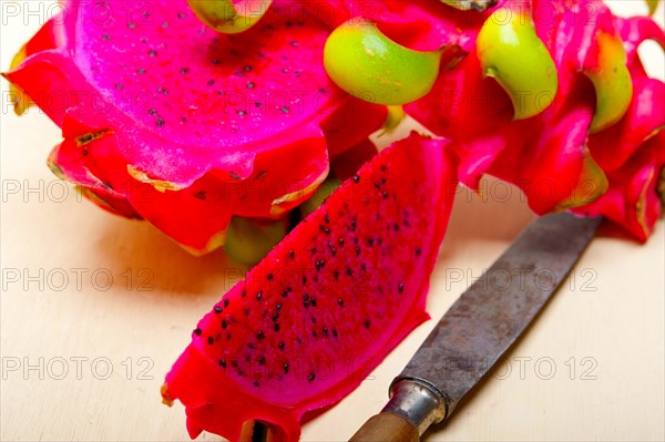 Fresh thai purple dragon fruit over white rustic table