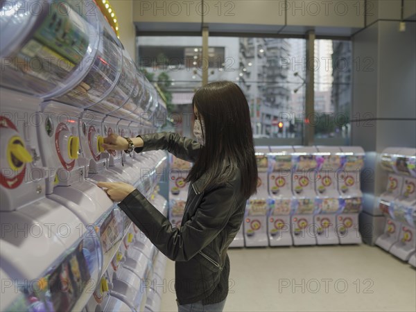 Girl at toy vending machine in Macau