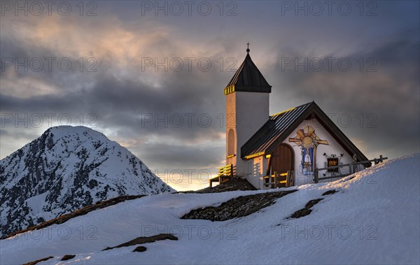 Alpine chapel of the Astenau-Alm at sunset