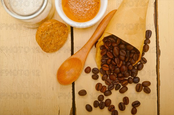 Espresso coffee and beans on a paper cone cornucopia over white background