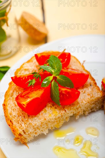 Italian tomato bruschetta with thyme and mint leaves