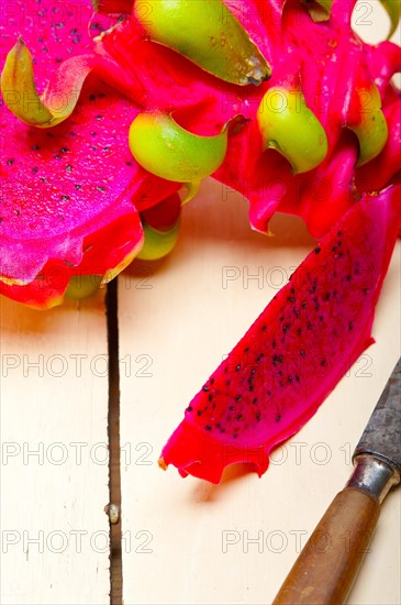 Fresh thai purple dragon fruit over white rustic table