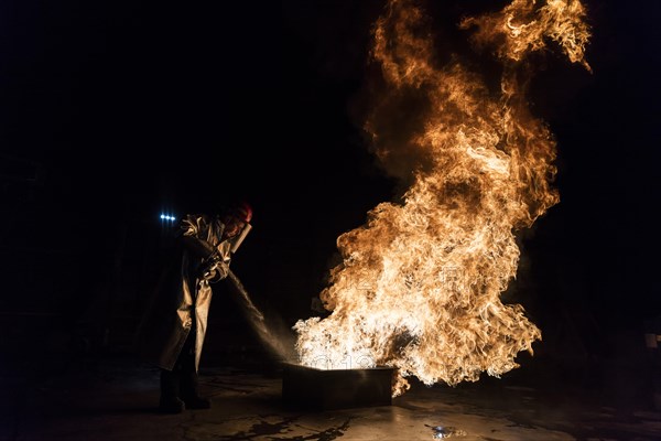 Firefighter extinguishes a heptane 2B-Pan fire with a 2-BTP extinguisher