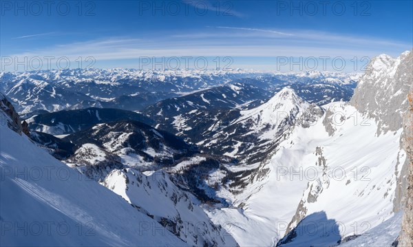 Blue sky over winter landscape and snow-covered Alpine peaks