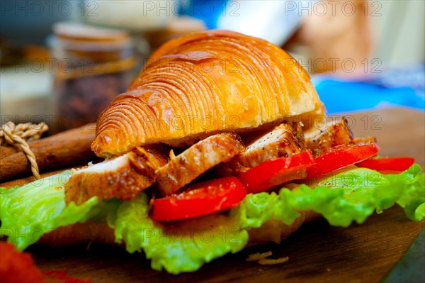 Savory croissant brioche bread with chicken breast and vegetable rustic style