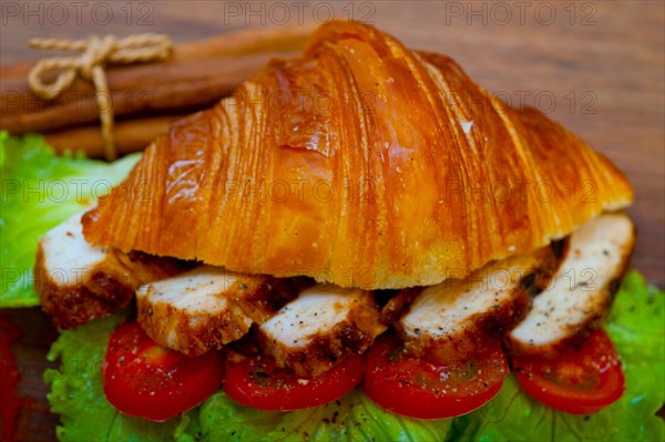 Savory croissant brioche bread with chicken breast and vegetable rustic style