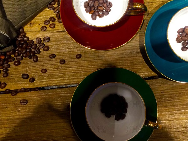 Coffee beans on bags over rustic wood background