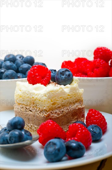 Fresh homemade raspberry and blueberry cream cake