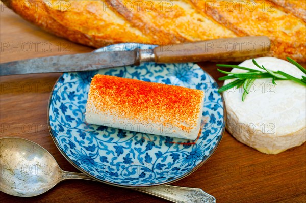 French cheese and fresh baguette on a wood cutter