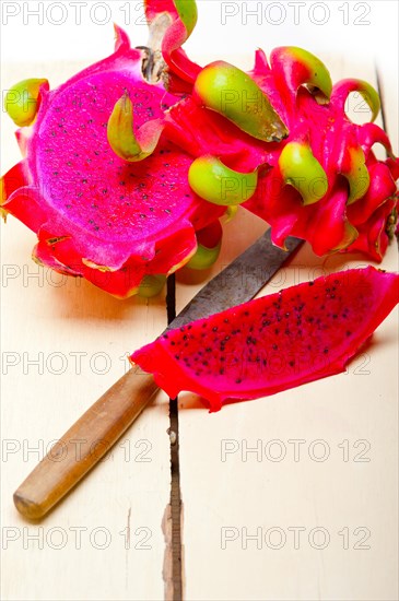 Fresh thai purple dragon fruit over white rustic table