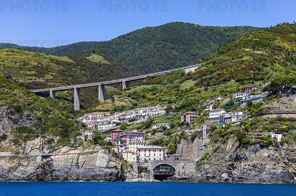 The village of Riomaggiore with its nested pastel-coloured houses built into the hillside