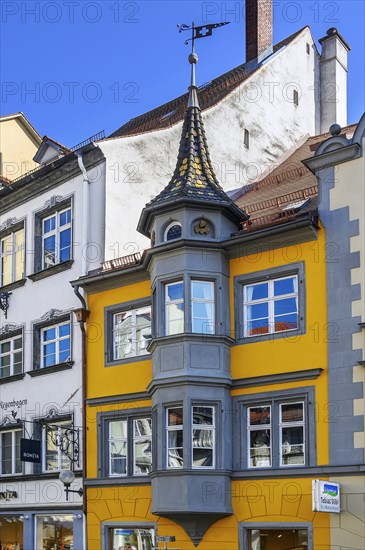 Orange facade with bay window and turret with weather vane