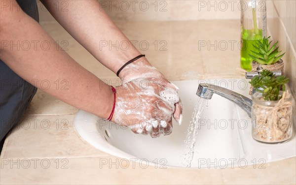 Close up of a person washing their hands with soap