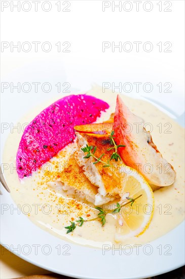 Sea bream orata fillet butter pan fried with fresh peach prune and dragonfruit slices thyme on top