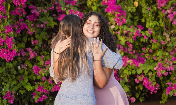 Two girlfriends hugging