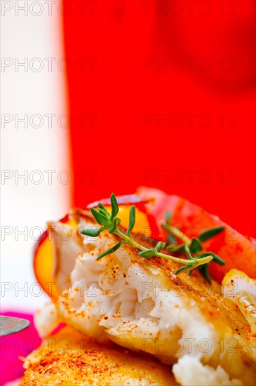 Sea bream orata fillet butter pan fried with fresh peach prune and dragonfruit slices thyme on top