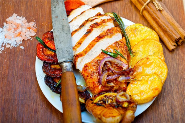 Roasted grilled BBQ chicken breast with herbs and spices rustic style