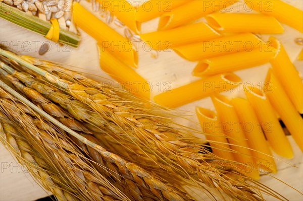 Short Italian pasta penne with durum wheat grains