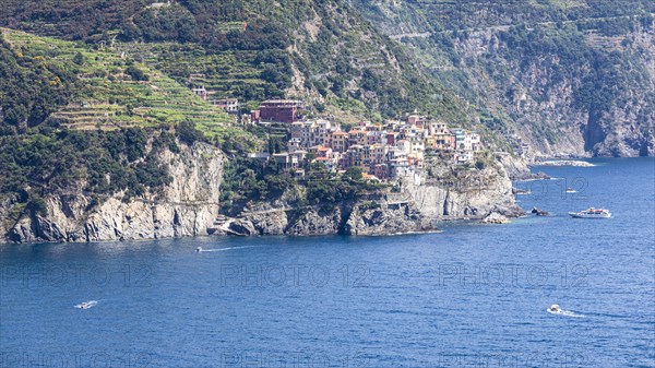 The village of Manarola with its nested pastel-coloured houses built into the hillside