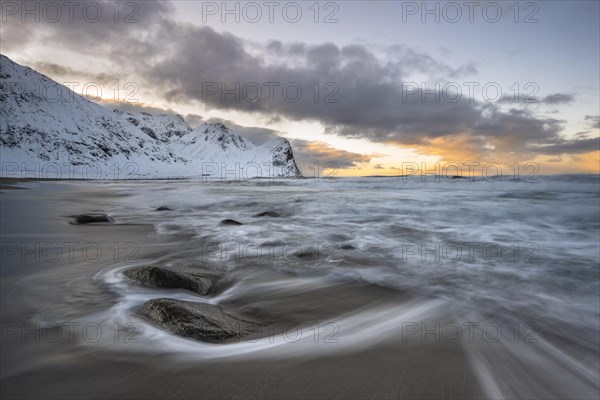 Beach with waves at sunset