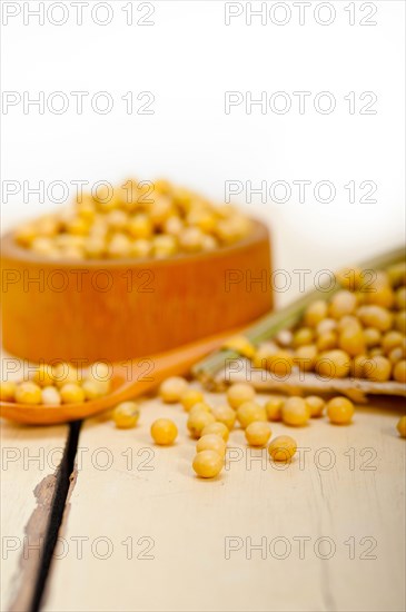 Organic soya beans over rustic wood table macro closeup