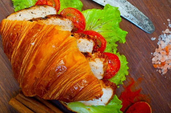 Savory croissant brioche bread with chicken breast and vegetable rustic style