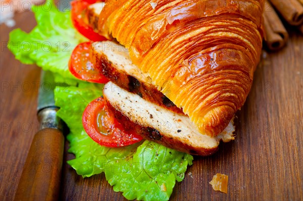 Savory croissant brioche bread with chicken breast and vegetable rustic style