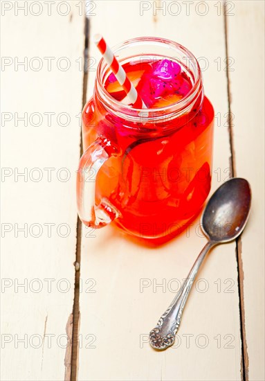 Fresh fruit punch refreshing summer drink over white rustic wood table