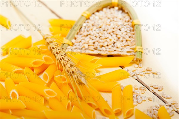 Short Italian pasta penne with durum wheat grains