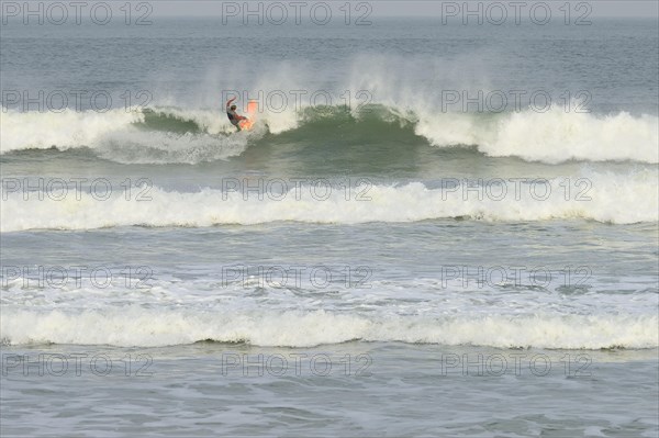 Surfer riding the wave at Praia de Mocambique