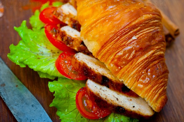 Savory croissant brioche bread with chicken breast and vegetable rustic style