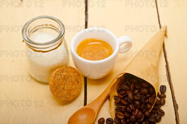 Espresso coffee and beans on a paper cone cornucopia over white background