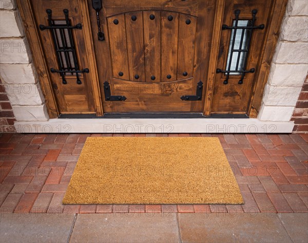 Blank doormat at the entrance of a house