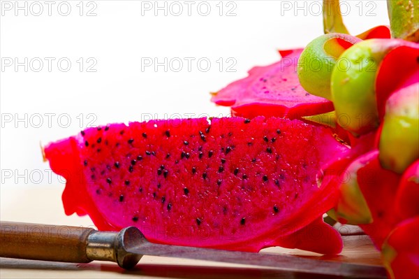 Fresh thai purple dragon fruit over white rustic table