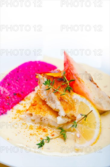 Sea bream orata fillet butter pan fried with fresh peach prune and dragonfruit slices thyme on top