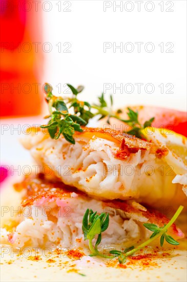 Sea bream orata fillet butter pan fried with fresh peach prune and dragonfruit slices thyme on top