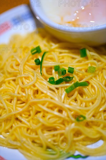 Traditional Japanese ramen noodles with poached egg on the side