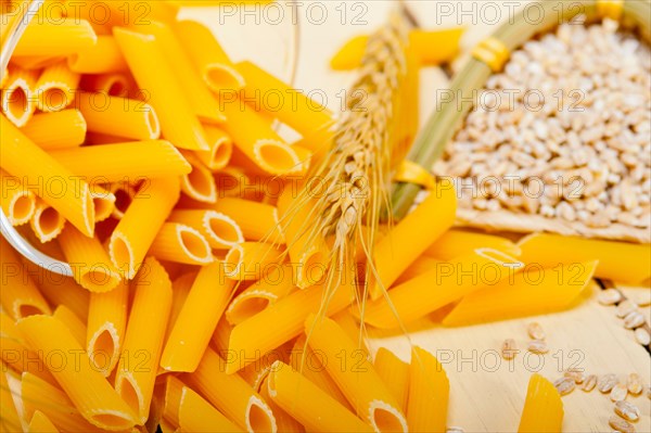 Short Italian pasta penne with durum wheat grains